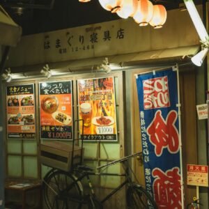 Shining Chinese lanterns above bike parked near cafe
